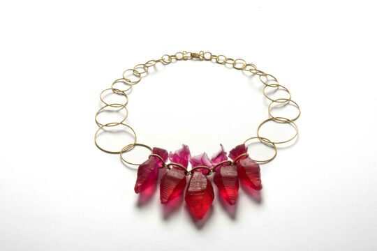 Ruby necklace
Necklace with cast ruby crystals dyed in resin with 18 carat gold chain.
Ruby likes to travel was the title for my solo exhibition in Gallery Mette Saabye, Copenhagen. It was an exhibition of ruby jewellery - not real rubies but rubies cast in resin. When visiting the exhibition the visitor could borrow any piece of the jewellery for a day. Each piece has a small suitcase and a logbook to go with it and the only requirement for borrowing the piece was to document the day in the logbook with a few photos and a text.
Photo Dorte Krogh